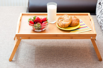 light breakfast on wooden tray