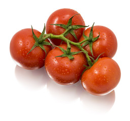 Five ripe tomatoes on a branch isolated on white background