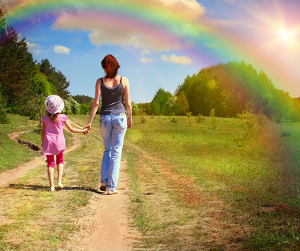 Mother with daughter on the green field