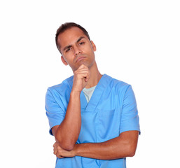Pensive guy nurse standing with hand on chin