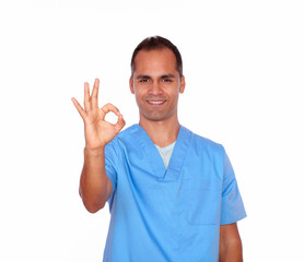Fototapeta premium Handsome nurse showing positive sign with hand