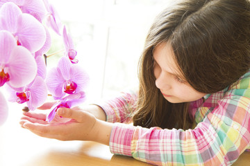 bambina ad ammirare l'orchidea