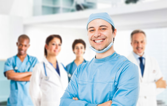 Smiling doctor in front of his team