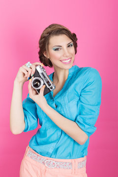 Cute retro young woman with analogue camera