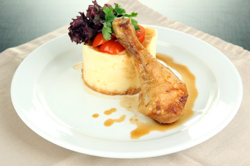 Small portion of food on big plate on wooden table