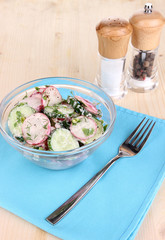 Vitamin vegetable salad in bowl on wooden table close-up