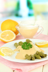 Asparagus on plate, on wooden table on bright background