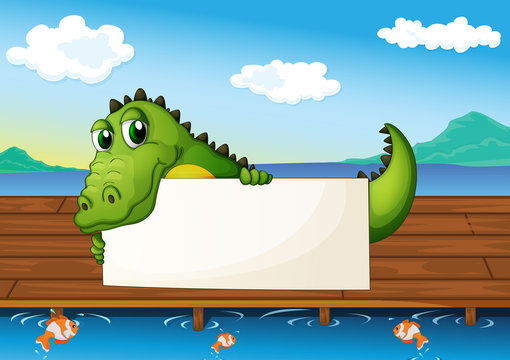 An alligator holding an empty signboard at the lake with fish