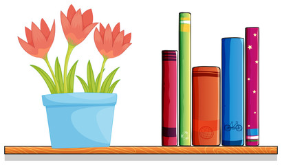 Obraz premium A wooden shelf with a pot of flower and books