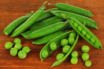 Sweet green peas on wooden background