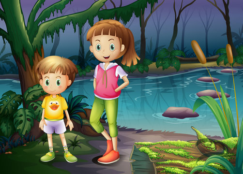 A boy and a girl standing in the middle of the forest