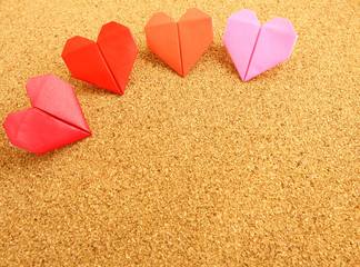 Origami colorful heart on corkboard