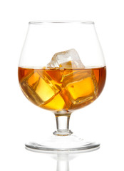 Brandy glass with ice isolated on white
