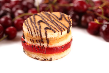 Tasty biscuit cake and berries isolated on white