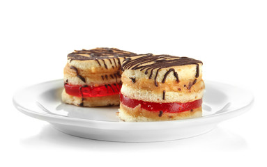 Tasty biscuit cakes on plate, isolated on white