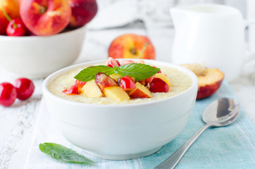 .Milk porridge with peaches and cherries