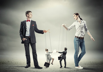 Businesspeople with marionettes