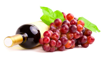 Bottle of red wine with grapes, white background