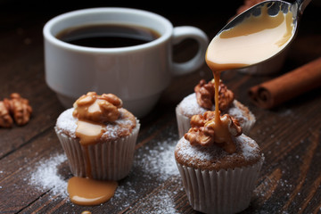Cupcake with nuts and flowing caramel