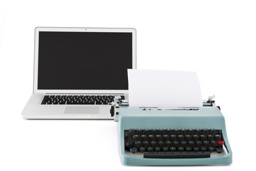 Old typewriter in front of contemporary laptop