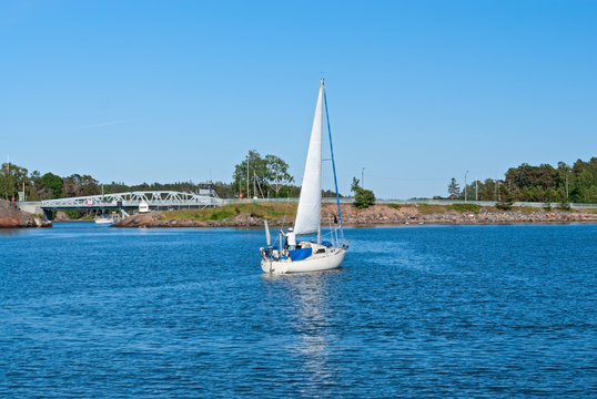 A sailboat  is afloat near Hevossalmi bridge (Helsinki, FI)
