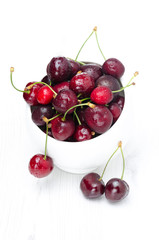 bowl of fresh cherries on a white background
