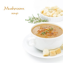 Mushroom cream soup with croutons and thyme isolated on white