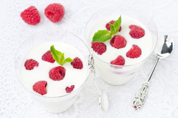 panna cotta with fresh raspberries in glasses, top view
