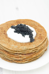 potato pancakes with sour cream and caviar selective focus