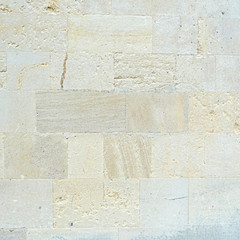 Natural limestone bricks wall texture or background