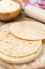 wheat tortillas on a wooden board selective focus