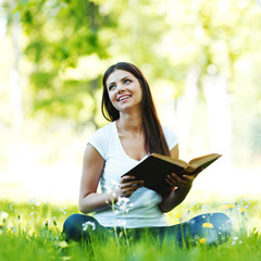 Woman reading book outdoors