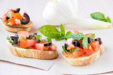 Classic Italian appetizer bruschetta with tomato, basil and blac