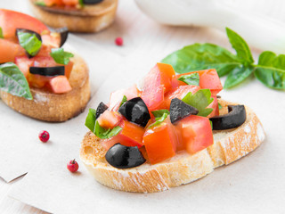Classic Italian appetizer bruschetta with tomato, basil and blac