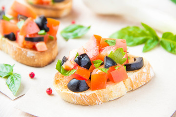 Classic Italian appetizer bruschetta with tomato, basil and blac