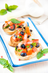 Classic Italian appetizer bruschetta with tomato, basil and blac