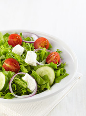 Fresh healthy salad with vegetables and goat cheese
