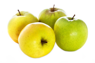 four fresh  yellow green apples isolated on a white background