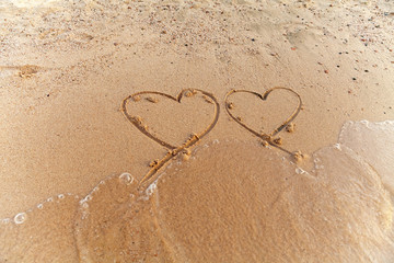 two hearts on sand
