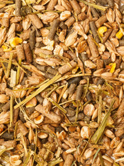 basic muesli  with herbs background for horse . close up