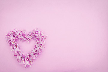 Lilac flower heart on textured background
