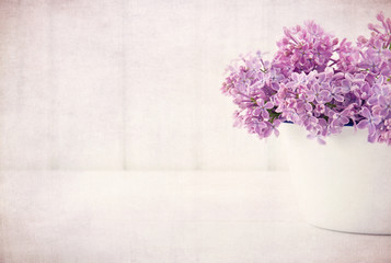 Purple lilac spring flowers on vintage textured background