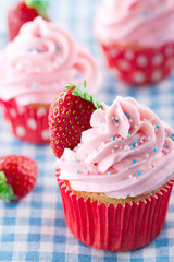 Strawberry cupcakes on vintage blue towel