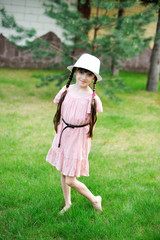 Amazing little girl in pink dress and white hat