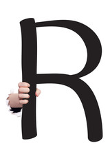 Hand breaking paper surface holding letter 'R'