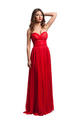 Beautiful female fashion model posing in red dress