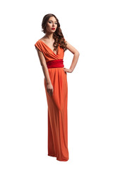 Model with beautiful long hair posing in orange dress isolated