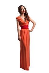 Model with beautiful long hair posing in orange dress isolated