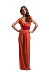 Fototapeta premium Model with beautiful long hair posing in orange dress isolated