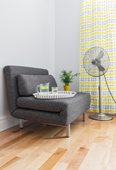 Living room with armchair and electric fan